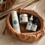 TSA-approved travel sizes of Skin Benefit medical-grade skincare products packed in a toiletry bag for on-the-go skin care