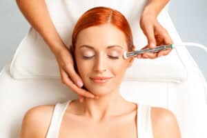 Gorgeous redheaded woman with flawless skin following microdermabrasion treatment in Nashville.